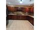 Spacious kitchen features tile floors, wood cabinets and granite countertops at 6210 Douglas Manor Ct, Douglasville, GA 30134