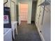 Laundry room featuring an open storage area and gray carpet at 6210 Douglas Manor Ct, Douglasville, GA 30134