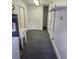 Laundry room featuring a sink, water heater, storage space, and gray carpet at 6210 Douglas Manor Ct, Douglasville, GA 30134