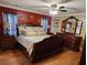 An ornate primary bedroom featuring a ceiling fan and hardwood floors at 6210 Douglas Manor Ct, Douglasville, GA 30134