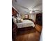 Main bedroom featuring hardwood floors, ceiling fan, and an ornate dresser and headboard at 6210 Douglas Manor Ct, Douglasville, GA 30134