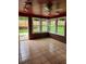 Enclosed sunroom with brick accents, tile flooring, and a view of the backyard at 6210 Douglas Manor Ct, Douglasville, GA 30134