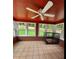 Inviting sunroom featuring brick walls, tile floor, windows overlooking the yard at 6210 Douglas Manor Ct, Douglasville, GA 30134