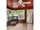 Bright sunroom with brick walls, tile floor, windows, and a dog crate at 6210 Douglas Manor Ct, Douglasville, GA 30134