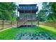 Exterior view of the deck and backyard with a wood fence and lush lawn with landscaping at 862 Hobson Street Southwest Sw St, Atlanta, GA 30310