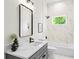 Bathroom featuring a marble-tiled shower and dark-grey vanity at 862 Hobson Street Southwest Sw St, Atlanta, GA 30310
