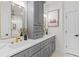 This bathroom features grey cabinets with gold hardware and a double vanity with a large framed mirror at 862 Hobson Street Southwest Sw St, Atlanta, GA 30310