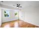 Sunlit bedroom featuring wood floors, white walls, large windows, and a ceiling fan at 862 Hobson Street Southwest Sw St, Atlanta, GA 30310