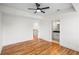 Neutral bedroom space with wooden floors, a ceiling fan, and an ensuite bathroom at 862 Hobson Street Southwest Sw St, Atlanta, GA 30310