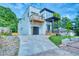 New construction home with a concrete driveway, black garage door and a second story balcony at 862 Hobson Street Southwest Sw St, Atlanta, GA 30310