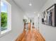 This hallway has wood flooring, a window with natural light, neutral paint and an art piece on the wall at 862 Hobson Street Southwest Sw St, Atlanta, GA 30310