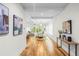 Hallway view leading to a dining room and living room with bright lighting and modern artwork at 862 Hobson Street Southwest Sw St, Atlanta, GA 30310
