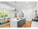 Kitchen island with stainless steel sink and faucet. Large window views open to a dining area and living room at 862 Hobson Street Southwest Sw St, Atlanta, GA 30310