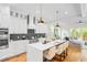 Modern kitchen featuring white cabinets, a white quartz island, and stainless steel appliances at 862 Hobson Street Southwest Sw St, Atlanta, GA 30310