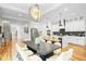 Open concept living, dining, and kitchen area featuring hardwood floors and bright lighting at 862 Hobson Street Southwest Sw St, Atlanta, GA 30310
