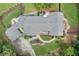 Detailed aerial shot of the home showing patio area, lush landscaping, walkways, and driveway at 980 Casteel Rd, Powder Springs, GA 30127