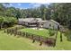 Aerial perspective of a fenced backyard including mature trees, a patio area, and lush lawn at 980 Casteel Rd, Powder Springs, GA 30127