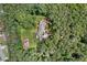 Overhead view of the property nestled within a wooded lot, featuring a large backyard and mature trees at 980 Casteel Rd, Powder Springs, GA 30127