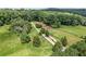 Expansive property featuring a long driveway, fenced pastures, mature trees, and plenty of green space at 980 Casteel Rd, Powder Springs, GA 30127