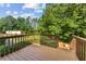 Wood deck offering views of the property's green lawn and lush, mature trees at 980 Casteel Rd, Powder Springs, GA 30127