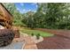 Backyard with a wooden staircase, lush lawn, privacy fence, and professional landscaping at 980 Casteel Rd, Powder Springs, GA 30127