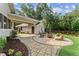 Backyard patio area with a grill, outdoor seating, and a fire pit with mature trees at 980 Casteel Rd, Powder Springs, GA 30127