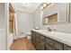 Spacious bathroom with white countertops, wood cabinet, and a shower/tub combo at 980 Casteel Rd, Powder Springs, GA 30127
