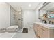 Modern bathroom featuring a glass shower, soaking tub, wood cabinets, and neutral finishes at 980 Casteel Rd, Powder Springs, GA 30127