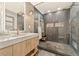 Modern bathroom featuring a walk-in shower with luxurious tile, stone counters, and gold hardware at 980 Casteel Rd, Powder Springs, GA 30127