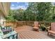 Relaxing wooden deck with comfortable seating and views of the wooded backyard at 980 Casteel Rd, Powder Springs, GA 30127