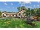Well-maintained home with beautiful landscaping, stone walkway, and mature trees creating a park-like setting at 980 Casteel Rd, Powder Springs, GA 30127