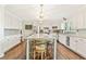 Bright, open kitchen with white cabinets, large center island with seating, and stainless steel appliances at 980 Casteel Rd, Powder Springs, GA 30127