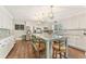 Stylish kitchen featuring a large island with bar stools, stainless appliances, and white cabinetry at 980 Casteel Rd, Powder Springs, GA 30127