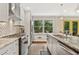 Bright kitchen featuring granite countertops, stainless steel appliances, and a view to the backyard at 980 Casteel Rd, Powder Springs, GA 30127