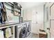 Well-organized laundry room with modern washer and dryer, ample cabinet space, and stylish decor at 980 Casteel Rd, Powder Springs, GA 30127