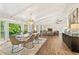 Open concept living and dining area with hardwood floors, large windows, and modern decor at 980 Casteel Rd, Powder Springs, GA 30127