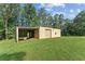 A large outbuilding/workshop with a shed-style roof, garage door, and open bay at 980 Casteel Rd, Powder Springs, GA 30127