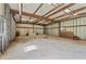 Large, open outbuilding interior with metal walls and ceiling, featuring a workbench area at 980 Casteel Rd, Powder Springs, GA 30127