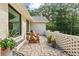 Beautiful outdoor patio featuring brick pavers, a brick privacy wall, and two wooden Adirondack chairs at 980 Casteel Rd, Powder Springs, GA 30127