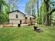 Backyard featuring an expansive wooden deck and a fire pit perfect for outdoor gatherings at 2816 Quinbery Dr, Snellville, GA 30039