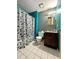 Standard bathroom features a toilet, vanity, sink, and shower/tub with decorative curtain at 2816 Quinbery Dr, Snellville, GA 30039