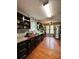 View of a long kitchen featuring granite countertops, stainless steel appliances, and wood-look flooring at 2816 Quinbery Dr, Snellville, GA 30039