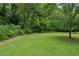Sprawling backyard featuring a lush lawn and a tree-lined perimeter, offering a private outdoor space at 2817 White Oak Ln, Decatur, GA 30032