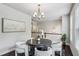 Stylish dining area with modern lighting, white chairs and an open view to the stairwell at 2817 White Oak Ln, Decatur, GA 30032