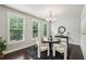 Elegant dining room with large windows, modern chandelier, and dark hardwood floors at 2817 White Oak Ln, Decatur, GA 30032