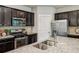 Modern kitchen with granite countertops, stainless steel appliances, and dark wood cabinetry at 2817 White Oak Ln, Decatur, GA 30032