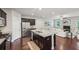 Open kitchen with a large island, dark cabinets, stainless steel appliances and living room at 2817 White Oak Ln, Decatur, GA 30032