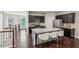 Modern kitchen with a large island, stainless steel appliances, and a view of the staircase at 2817 White Oak Ln, Decatur, GA 30032