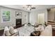 Bright living room features a fireplace, ceiling fan, dark wood floors, and access to outdoor space at 2817 White Oak Ln, Decatur, GA 30032