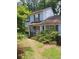 Light blue home with a covered front porch and an overgrown yard at 2939 Carrie Farm Nw Rd, Kennesaw, GA 30144